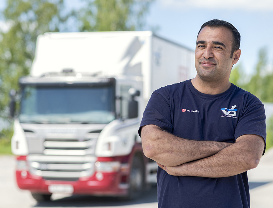Man standing confidently in front of his big rig